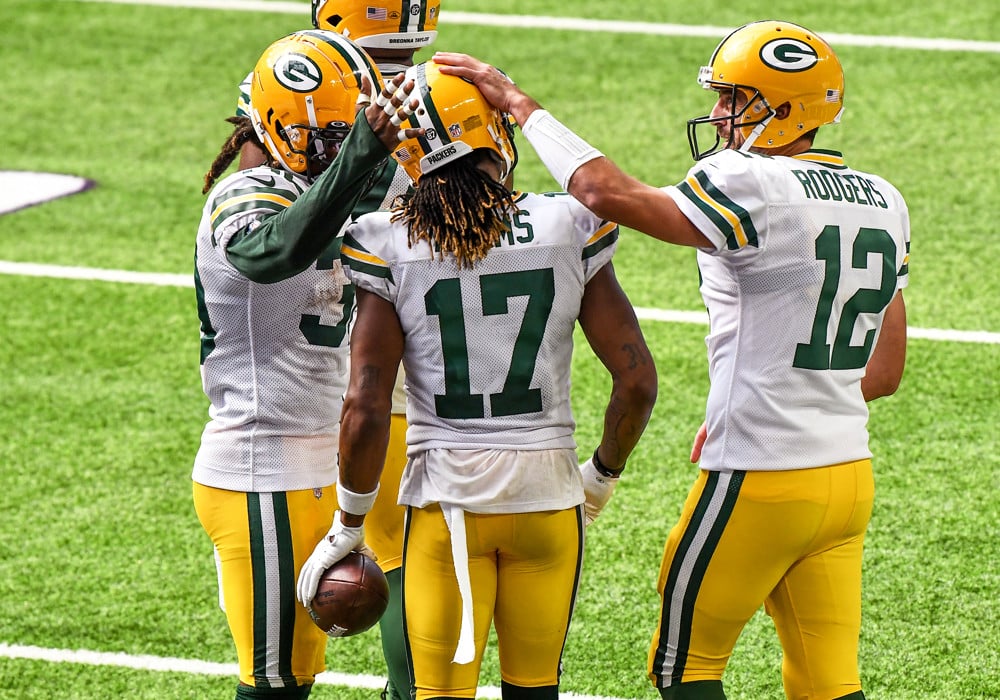 NFL Player Props | Tampa Bay Buccaneers at Green Bay Packers Packers Wide Receiver is congratulated by his teammates after scoring a touchdown. Will he get them to the Superbowl?